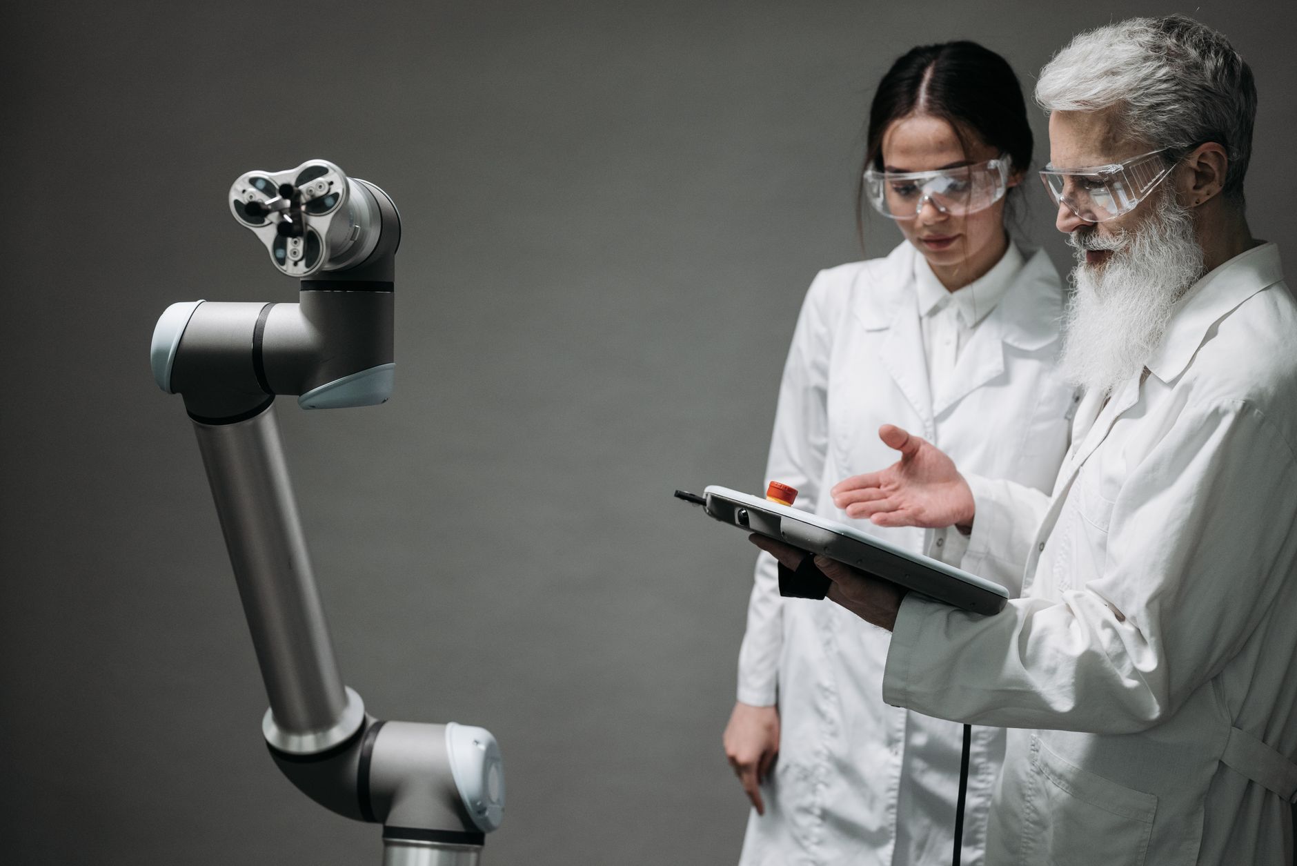 Największe błędy przy trenowaniu modeli AI na danych z produkcji i sposoby, by ich uniknąć Naukowcy w fartuchach testują ramię robota w laboratorium